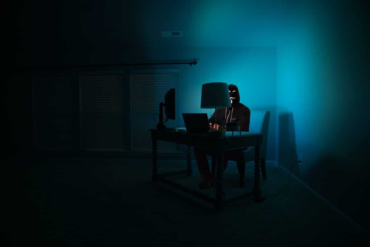 A crypto hacker sitting in front of a computer 