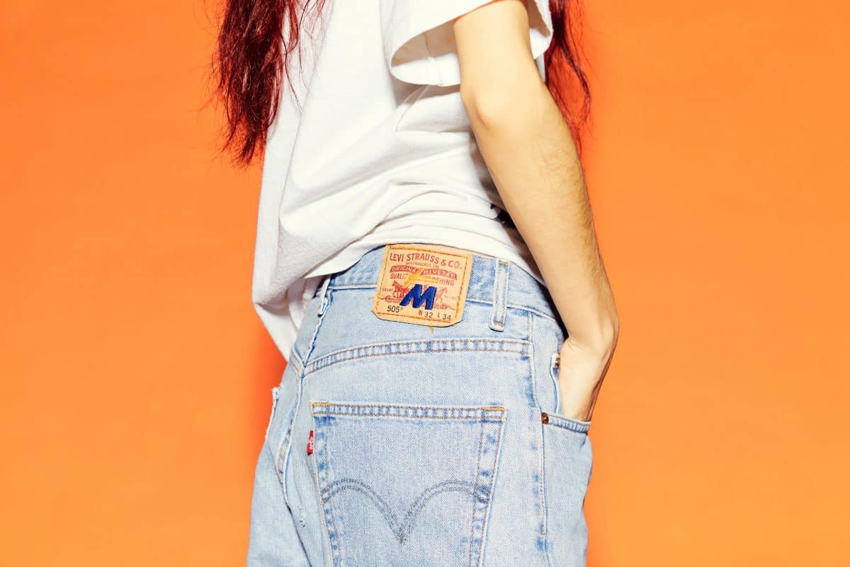 A picture of a model wearing MNTGE Fruits & Veggies Levi's jeans. 